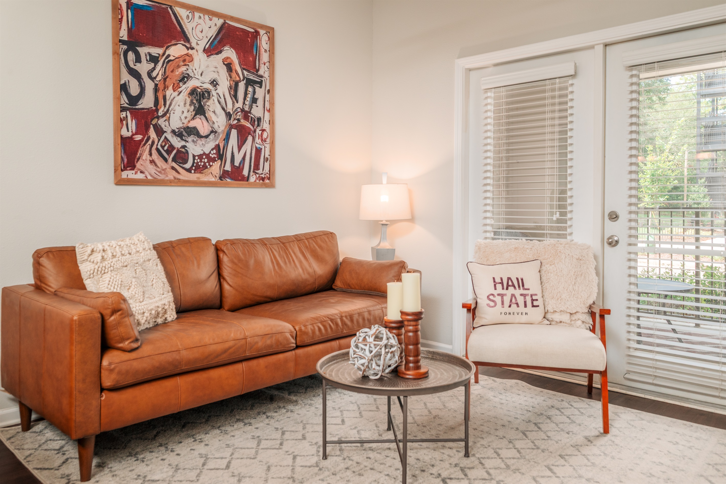 Kick back in this cozy, light-filled living room with Bulldog spirit — the perfect place to gather, relax, and get game-day ready.