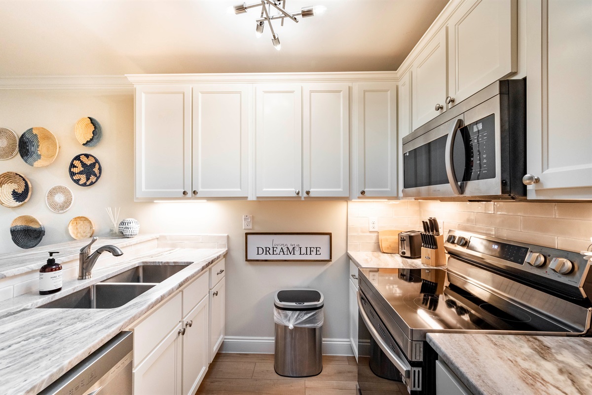 Cook your favorite meals in this fully stocked kitchen with a sleek stovetop, oven, and microwave.