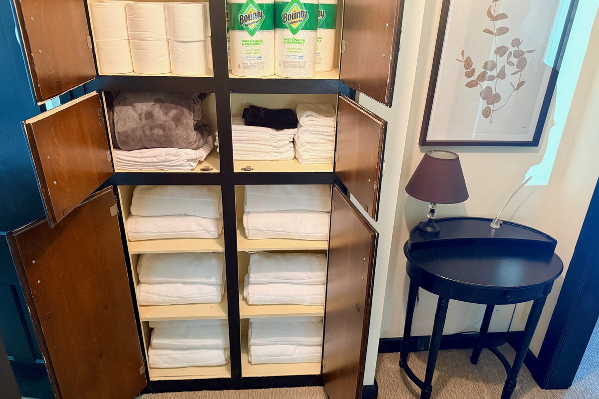 Built-in storage stocked with fresh linens and extra bedding.