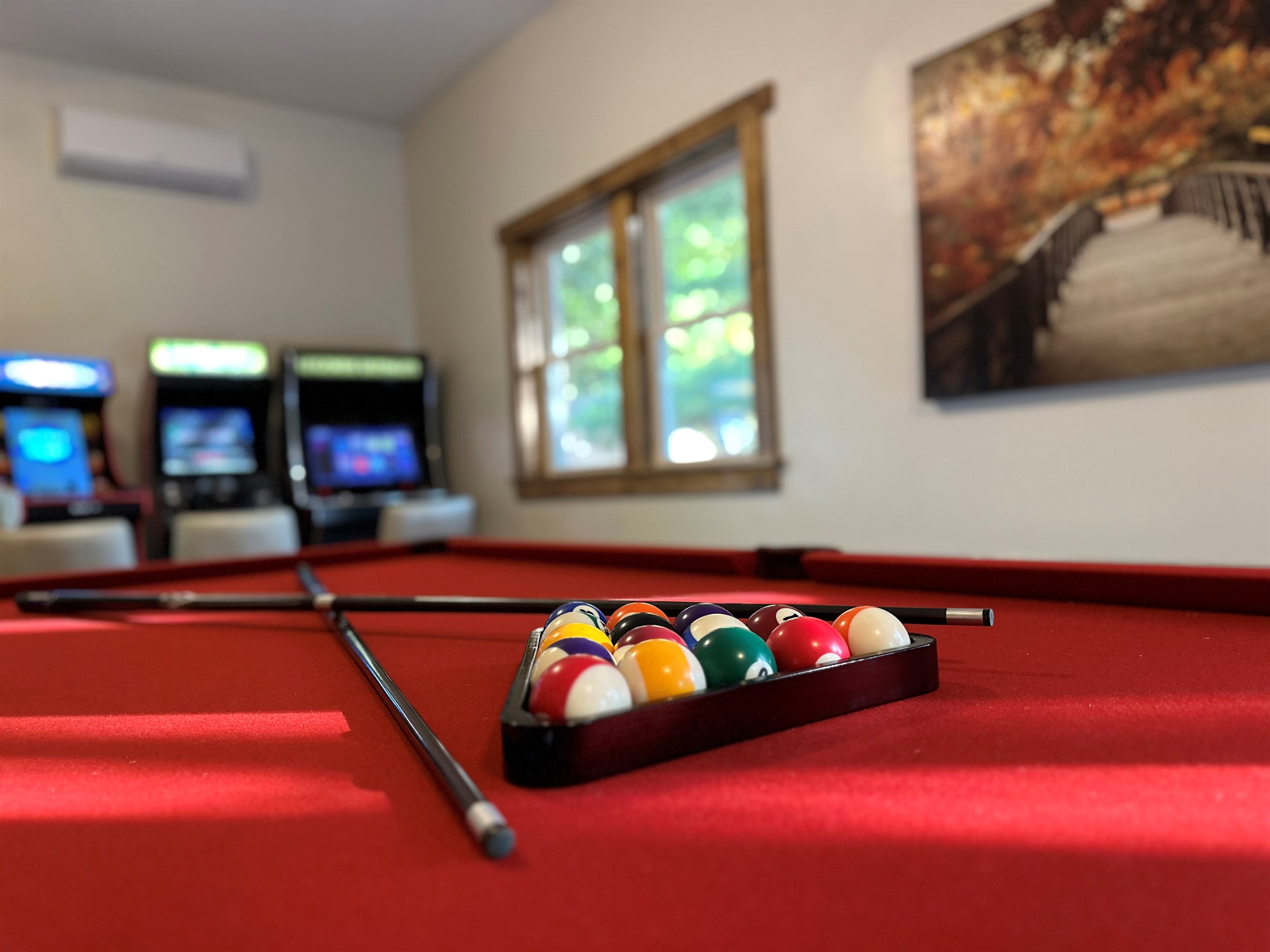 Game room with 8 foot Olhausen pool table, classic arcade games, and AC. Perfect for family fun and rainy day entertainment.