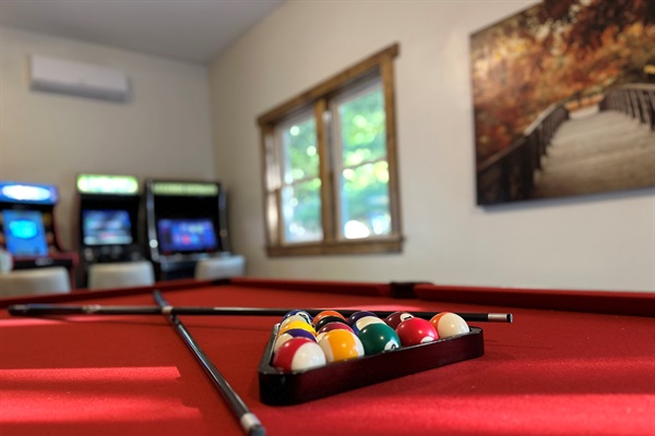 Game room with 8 foot Olhausen pool table, classic arcade games, and AC. Perfect for family fun and rainy day entertainment.