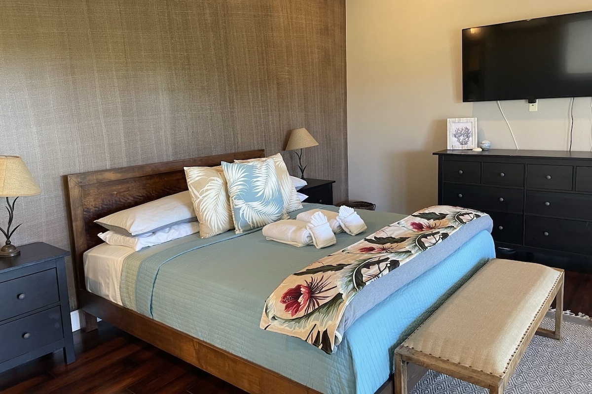 Primary bedroom has a large, Cal-King bed plus a ceiling fan for comfort.