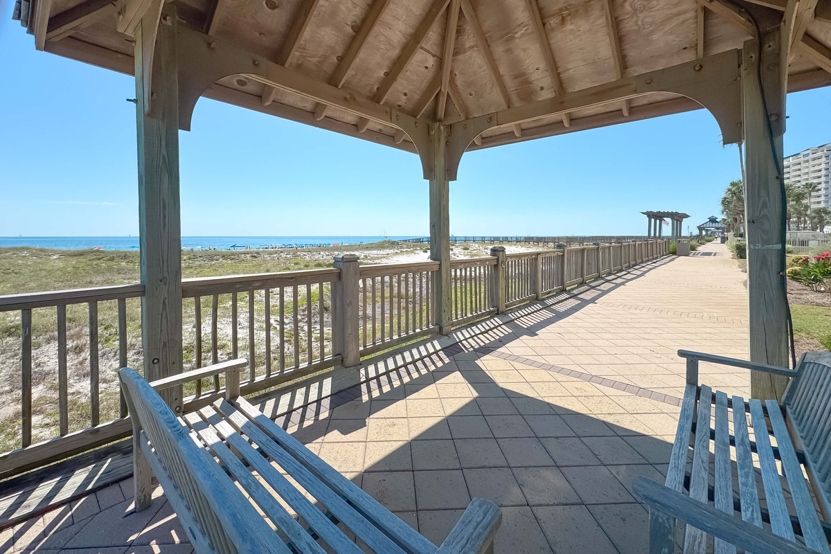 The charming pergola with its comfortable swings perfectly frames the captivating ocean view, creating an inviting and sophisticated atmosphere.