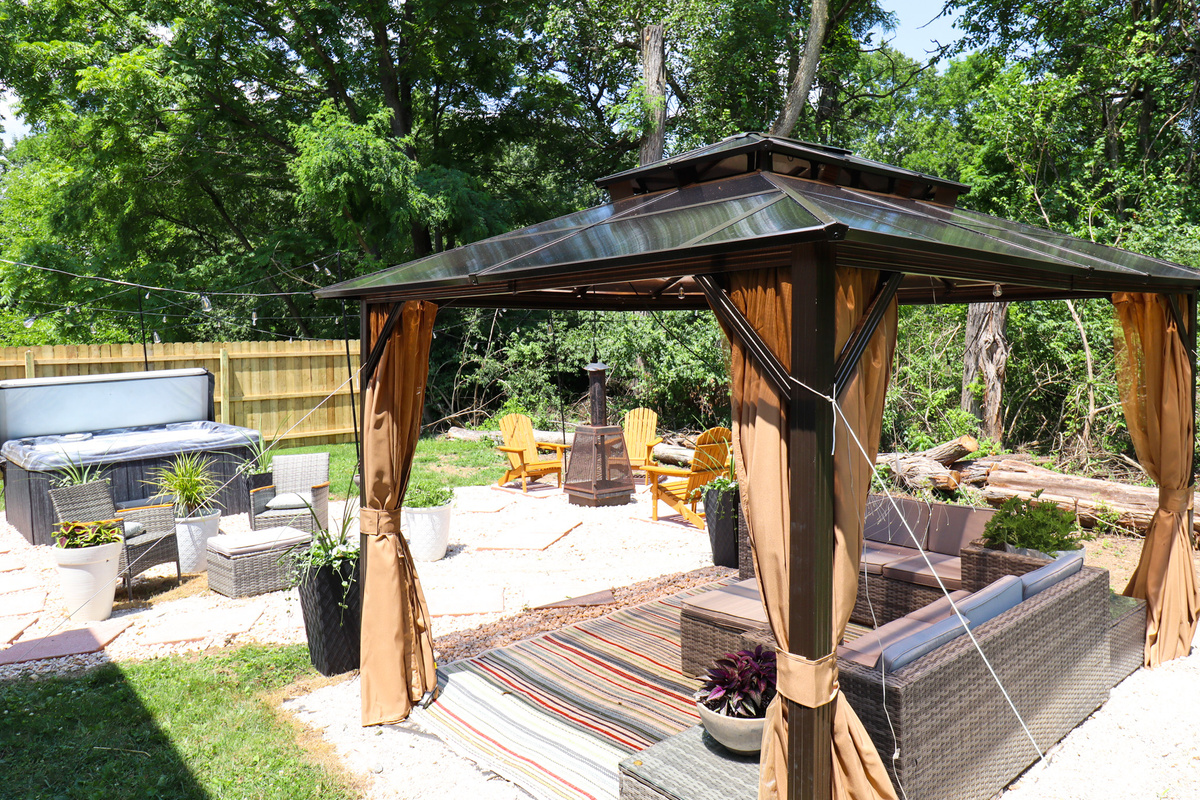 Gather beneath the gazebo around the cozy fire table day or night