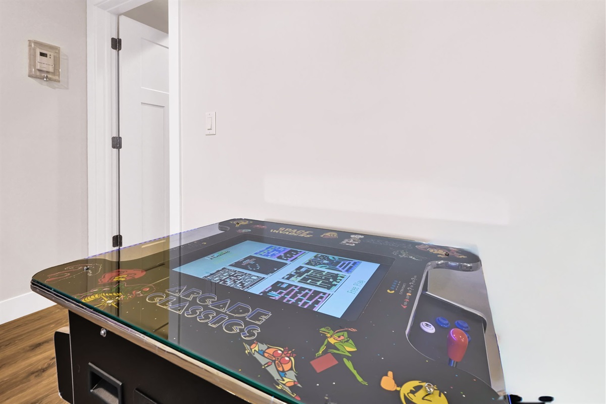 Classic cocktail-style arcade table with retro games — fun for all ages.