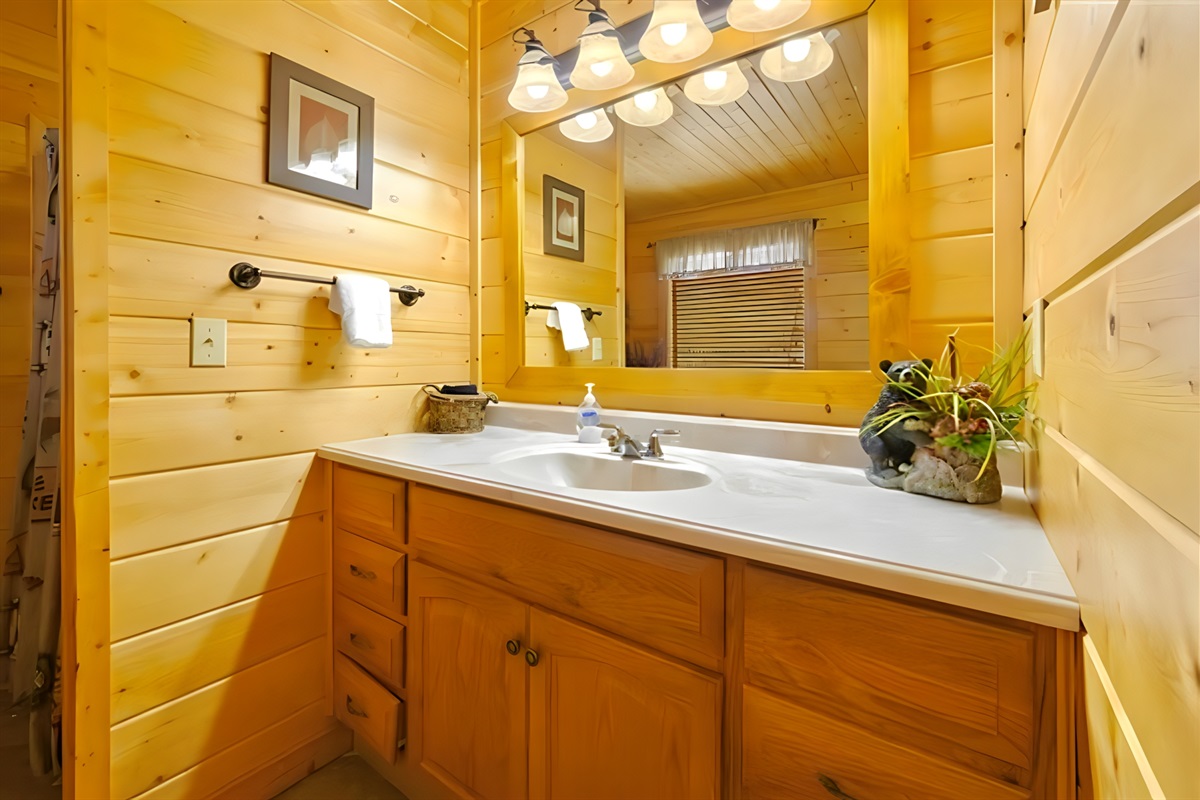 Bathroom #1 – Begin your day in this sunny cabin bathroom, where warm wood tones and soft lighting make every morning feel peaceful and fresh.