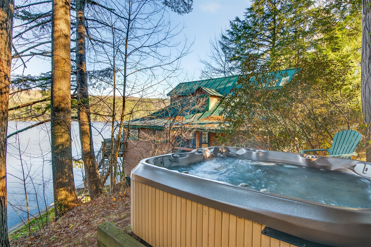 Inviting outdoor hot tub overlooking the lake, offering a warm and soothing spot to enjoy peaceful moments day or night