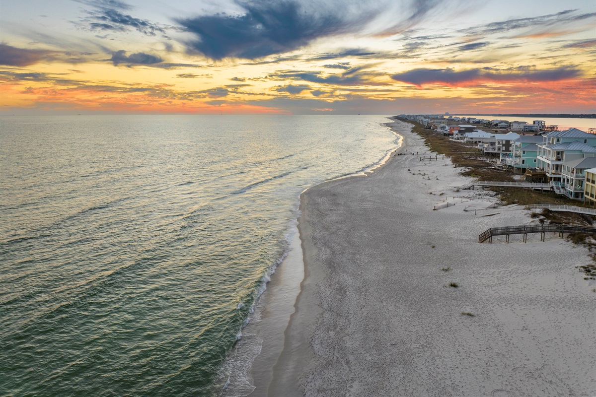 Peaceful beachside sunset with vibrant skies and tranquil coastal charm in Gulf Shores, AL.