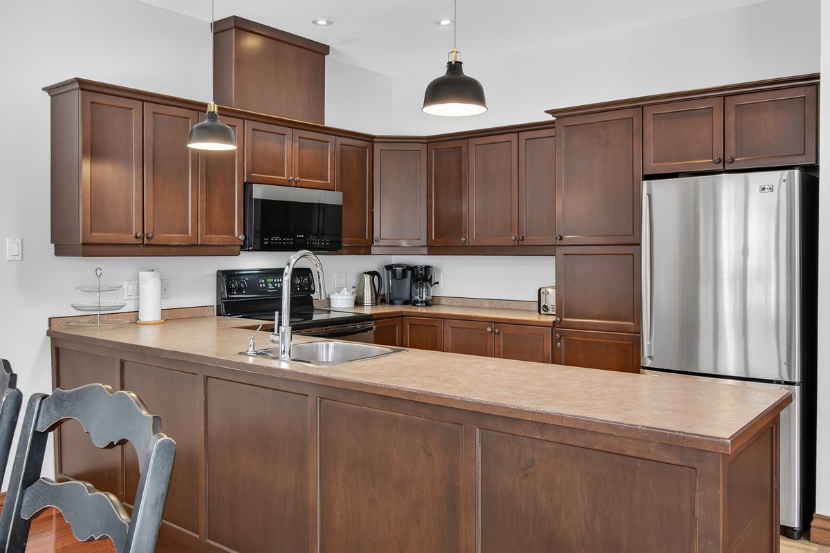 Spacious kitchen w/ generous counters & warm finishes.