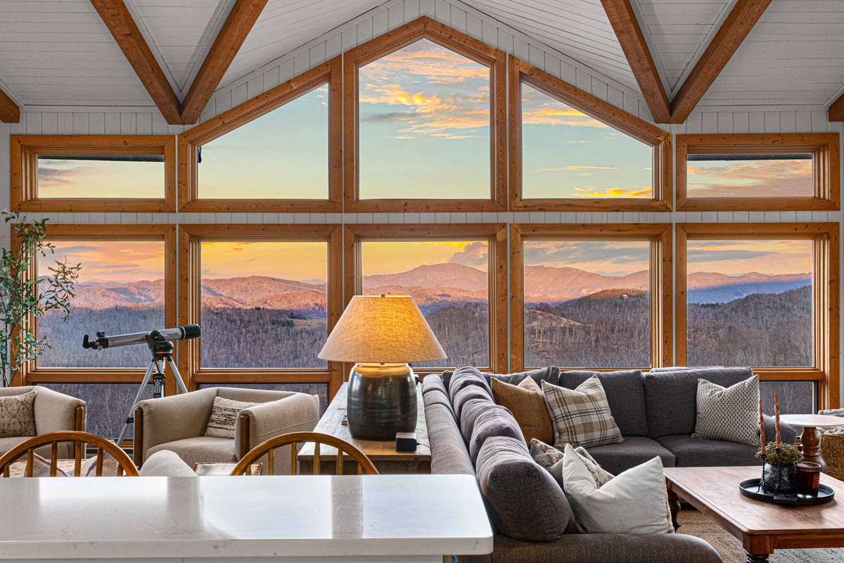 Wall of windows frames sweeping mountain views—sunrise coffee and sunset lounging come standard.