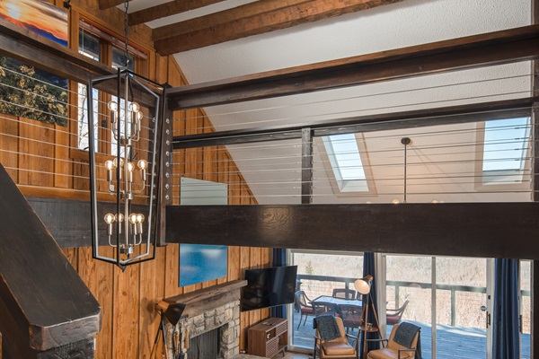 Step downstairs to a cozy living room, kitchen, dining area, and spacious deck.  