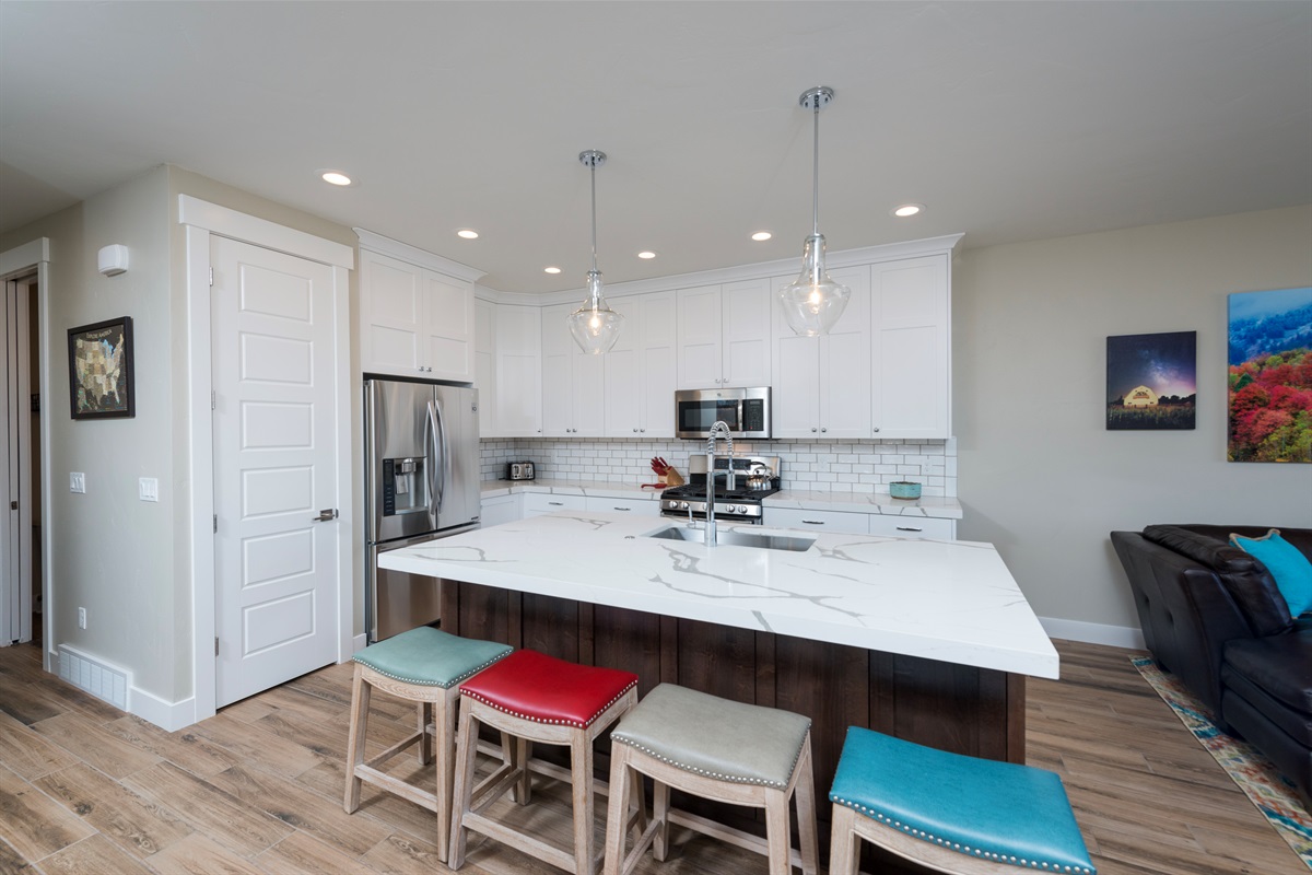 Fully stocked gourmet kitchen with modern finishes and room to create