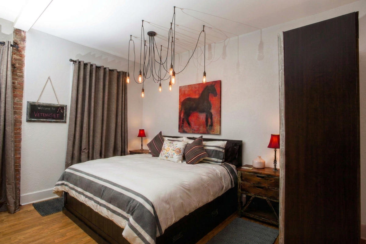 Plantera’s king-size bed with Casper mattress offers charging stations on the nightstands - blackout shades cover the historic original double hung windows overlooking Main Street