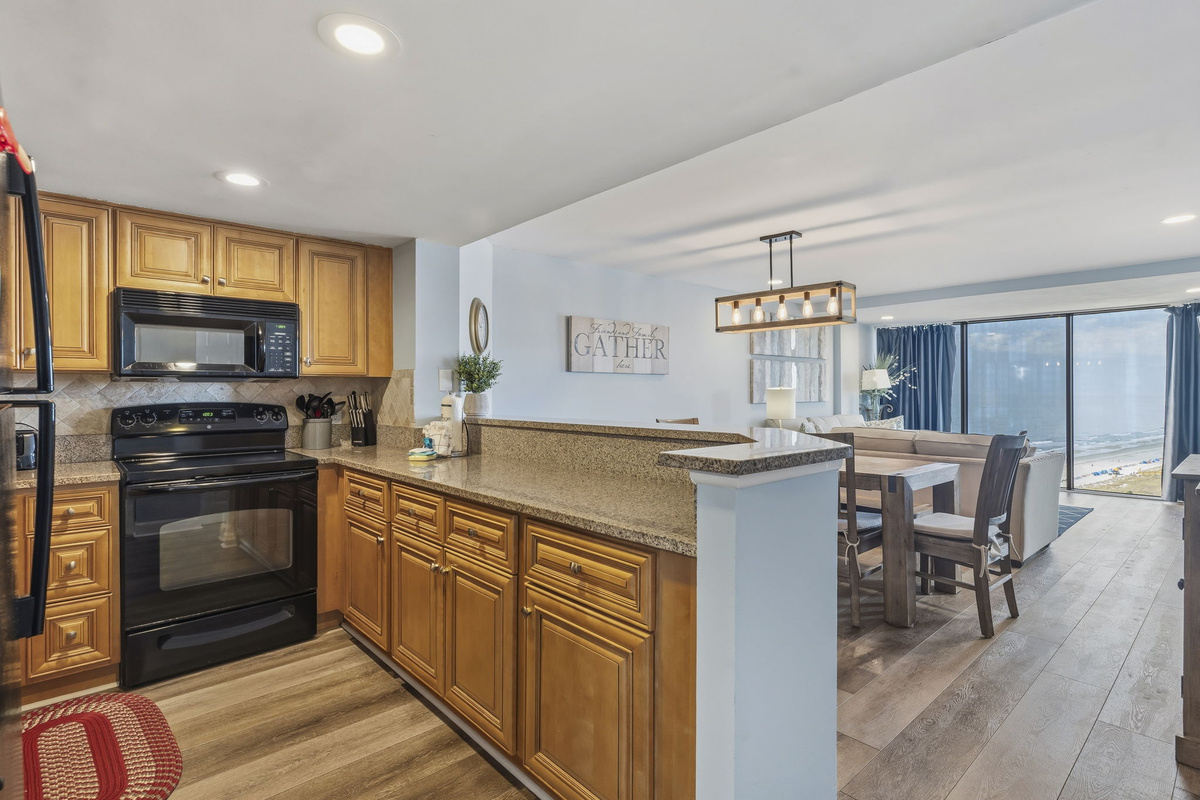 Kitchen with granite countertops opening to the dining area