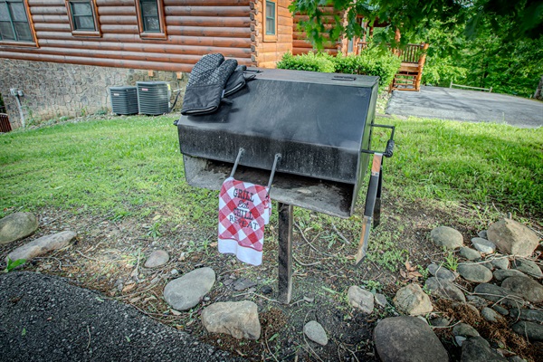 Charcoal grill located just down the steps off the main porch - ready for classic cookouts in the mountain air.