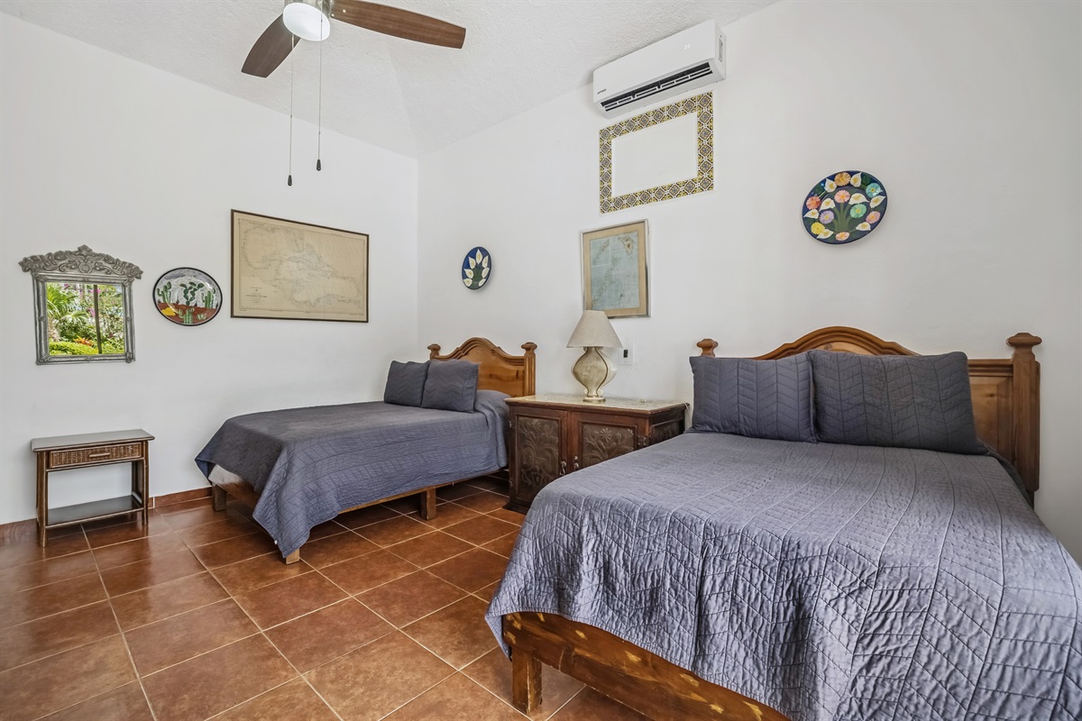 Bedroom 2 on Main Floor with Shared Bathroom and Access to Backyard