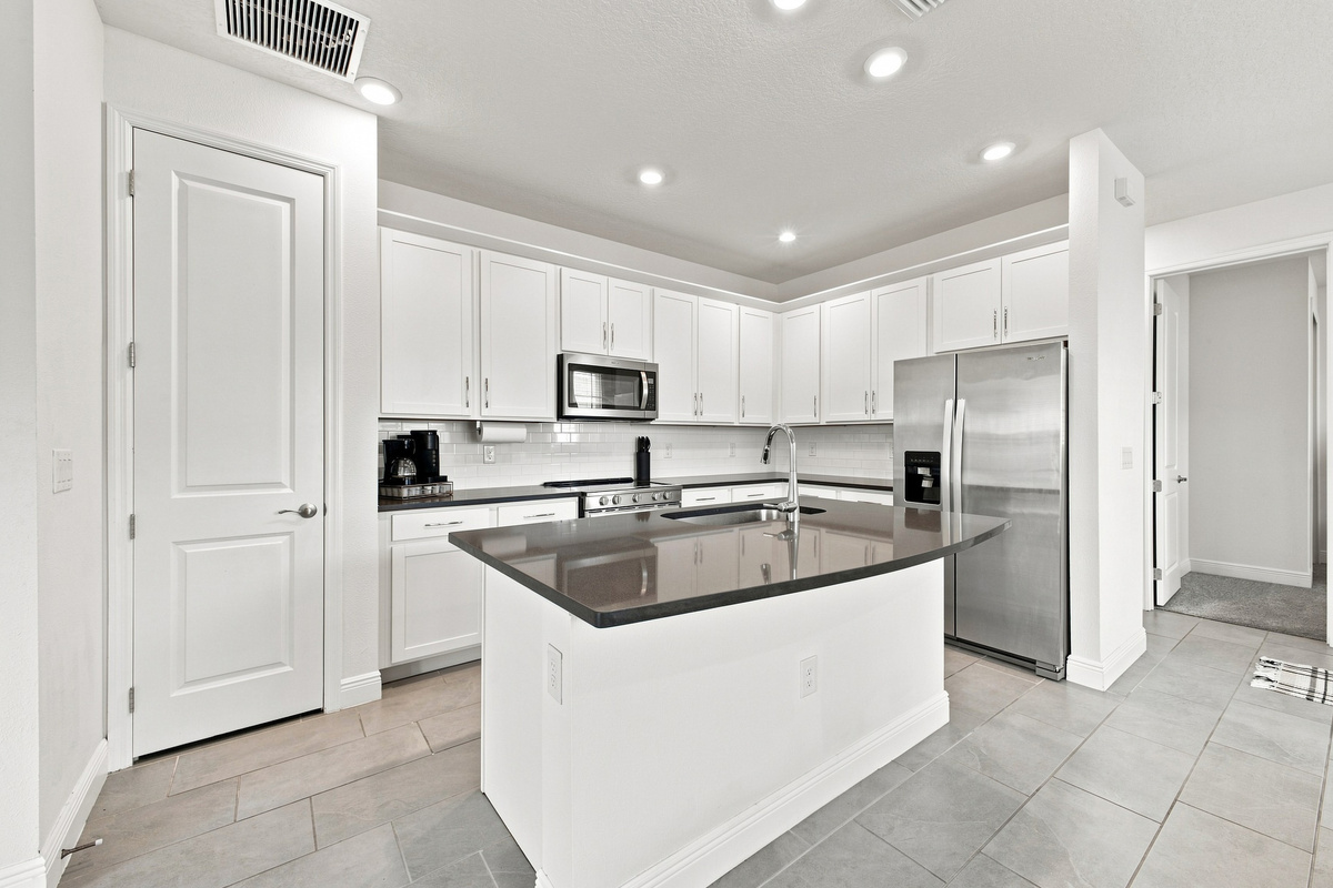 Plenty of pantry and cabinet space, stocked with all kitchen amenities. 