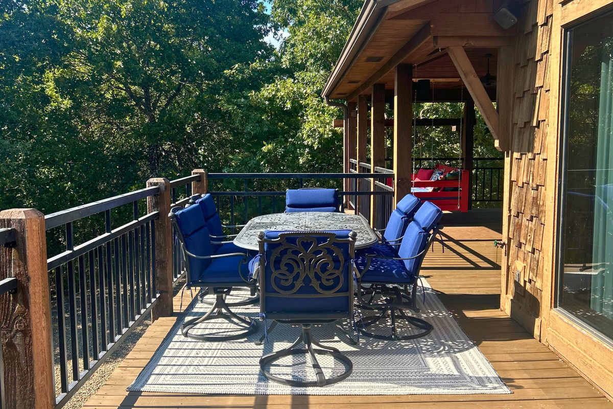Step outside to a spacious open deck where Adirondack chairs and a table create an easy place to sit back and enjoy the surrounding trees.