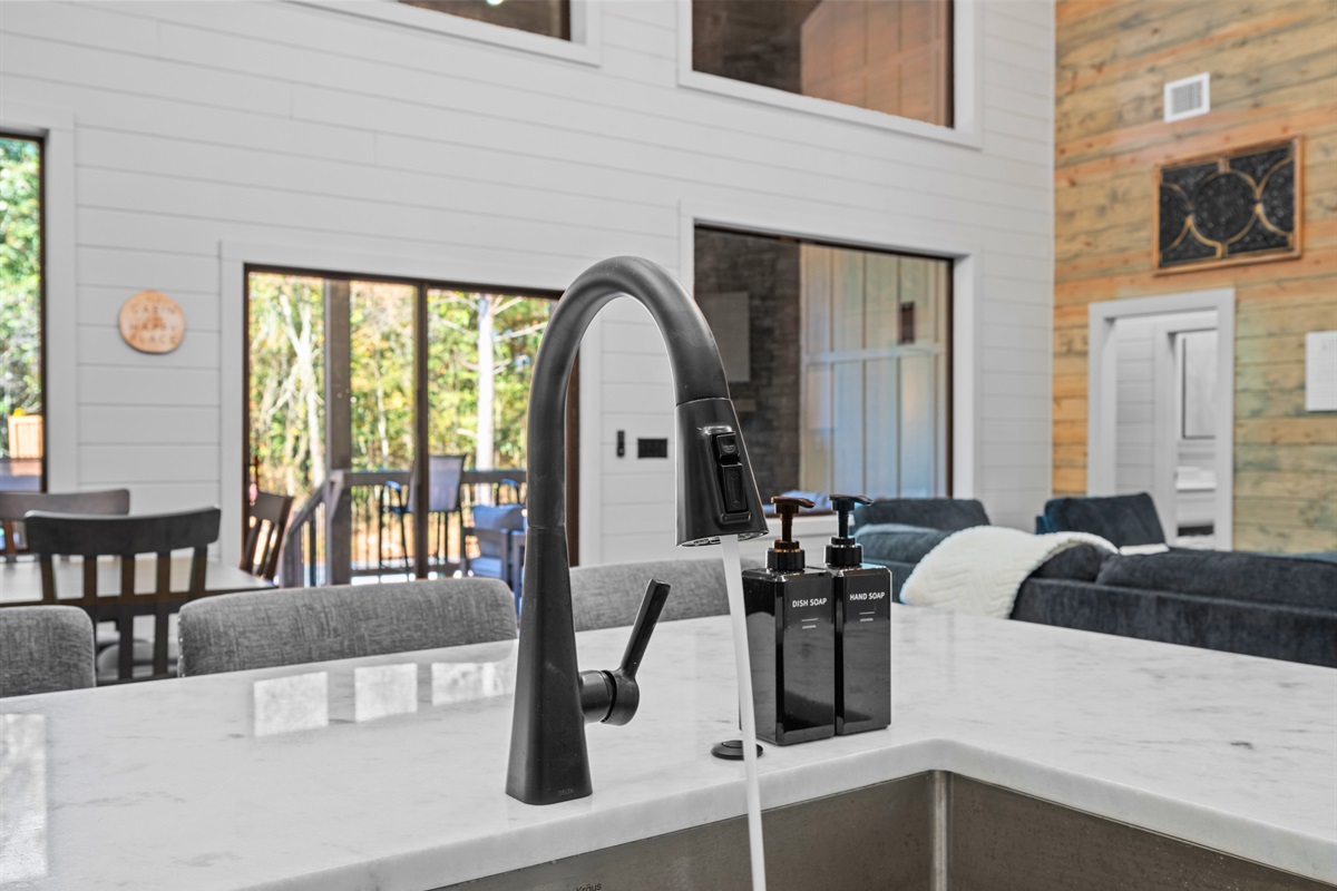 Oversized windows bring in natural light, giving the kitchen and dining area an easy, welcoming feel.