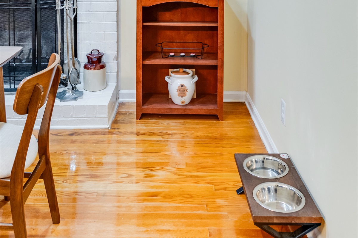Bright and inviting space with a charming fireplace and lovely artwork, perfect for relaxation! Pet bowls are available all over the property. 