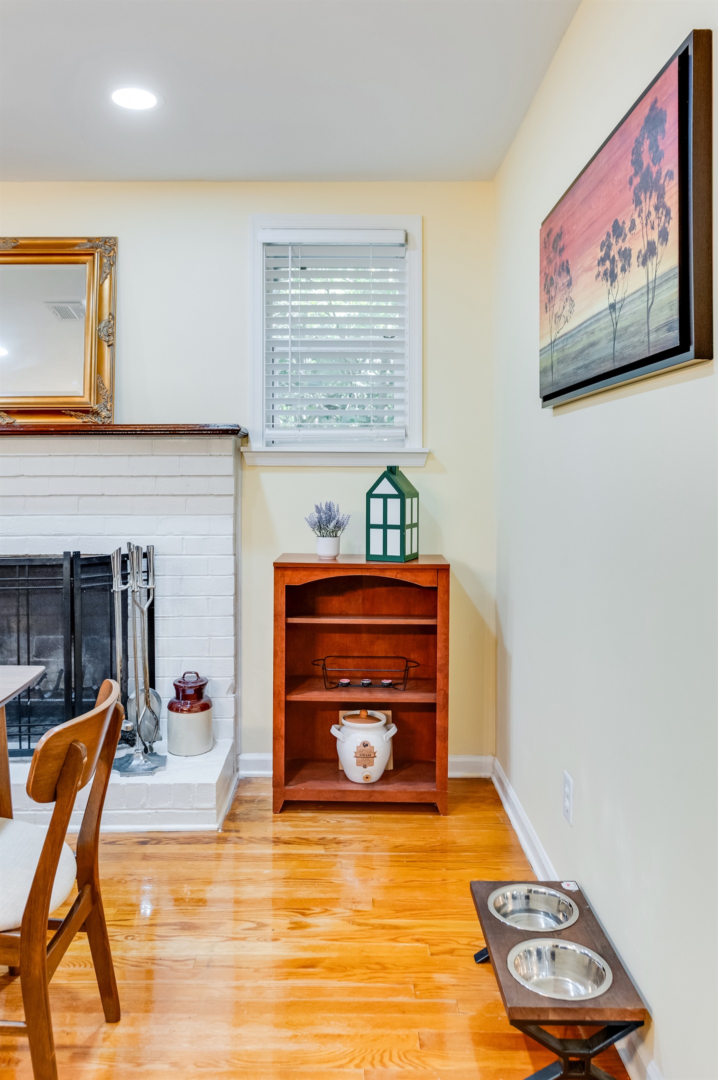 Bright and inviting space with a charming fireplace and lovely artwork, perfect for relaxation! Pet bowls are available all over the property. 
