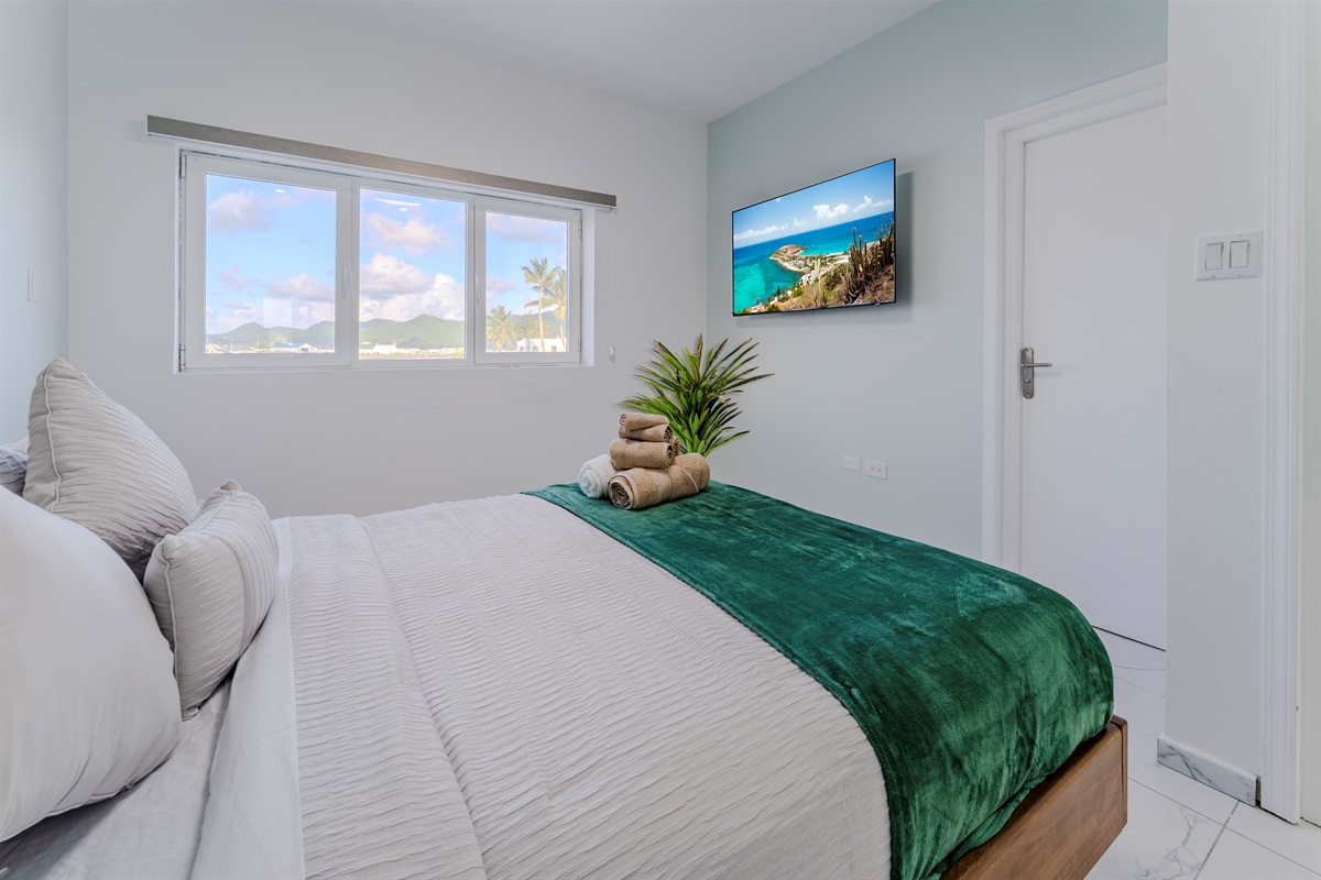 Light‑Filled Bedroom with Queen Bed & Cozy White Linens