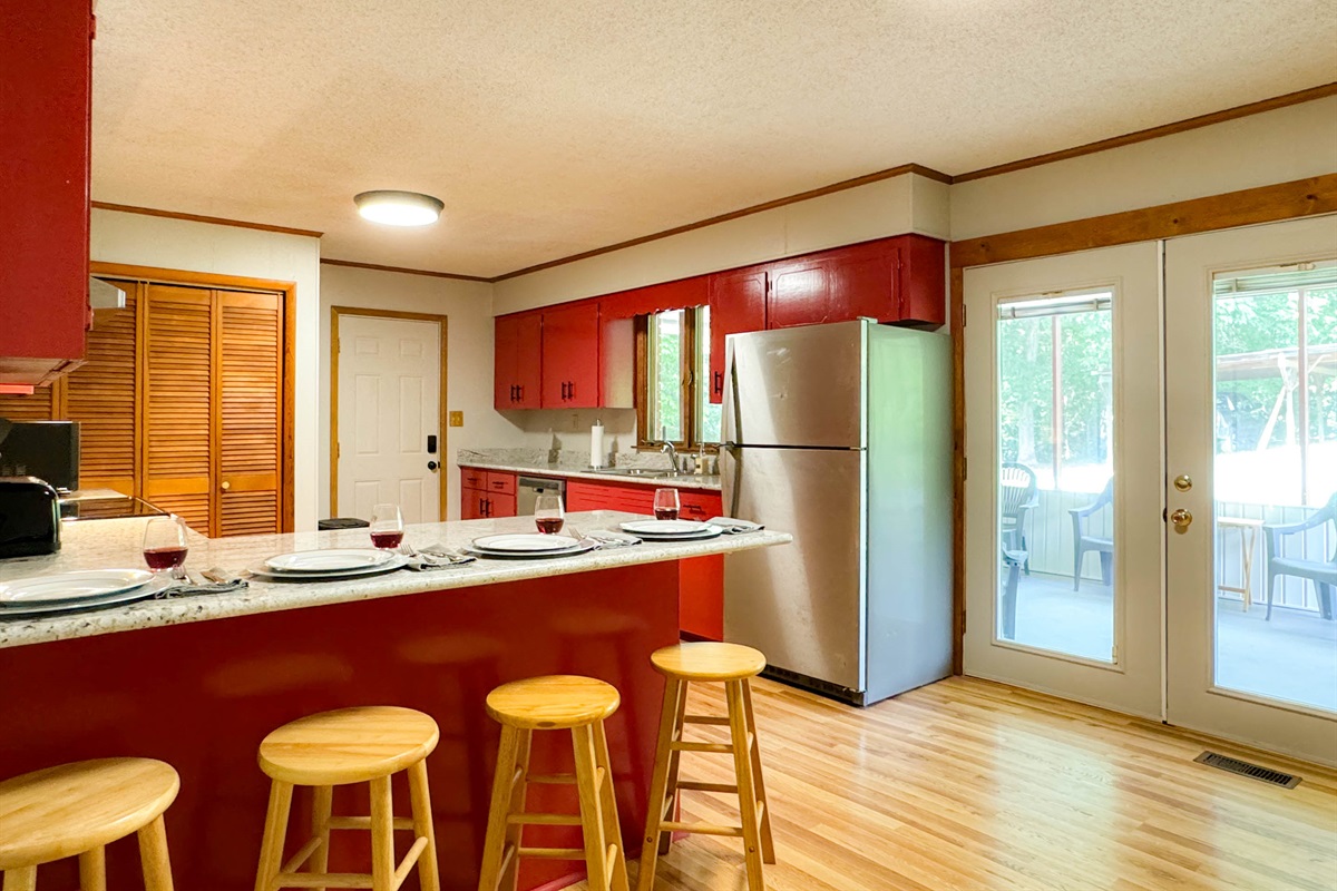 The kitchen has granite countertops with 4 top bar seating and a small dining table for up to 4 as well.