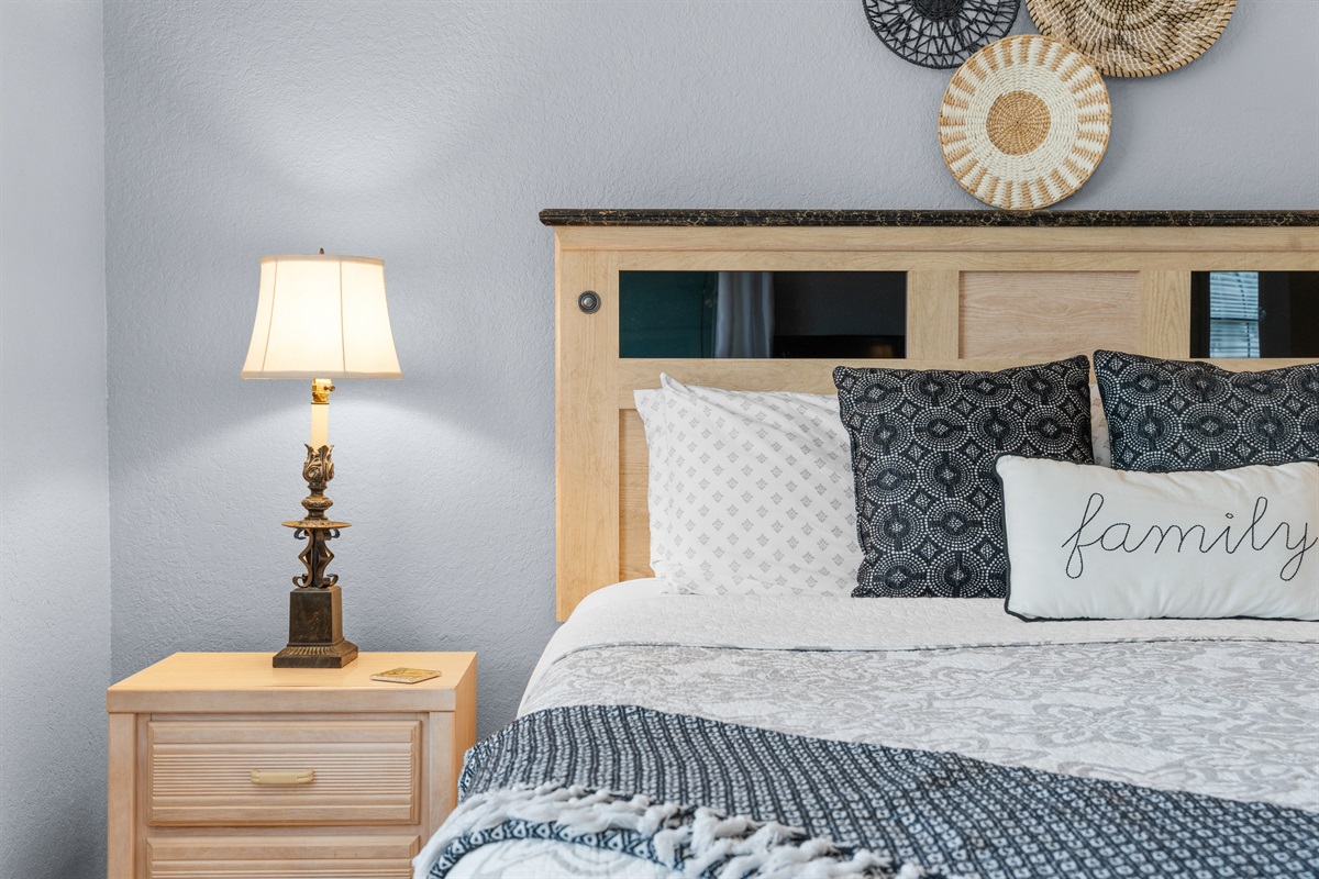 Warm lighting and bedside space keep the room comfortable for winding down.