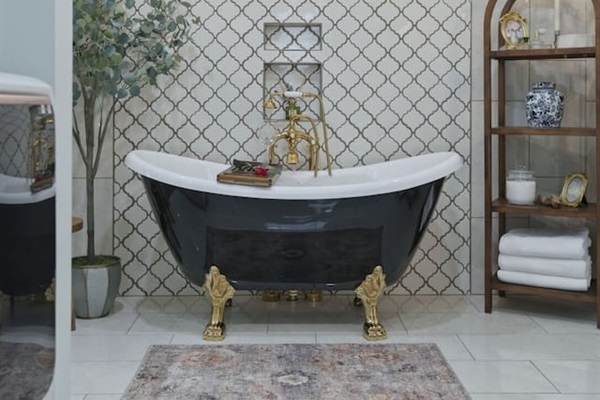Charming clawfoot tub centerpiece with elegant details and a bright, airy design for a true spa-like escape
