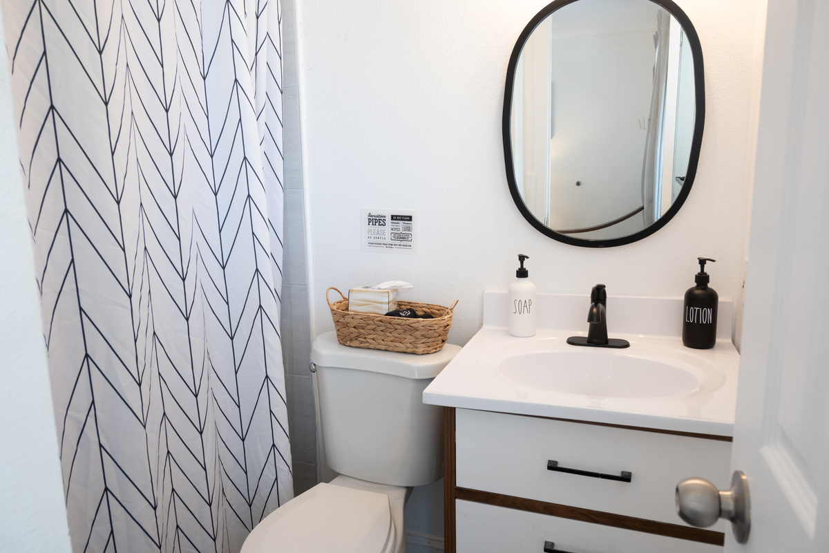 Modern bathroom with walk-in shower, modern vanity and hotel-style toiletries
