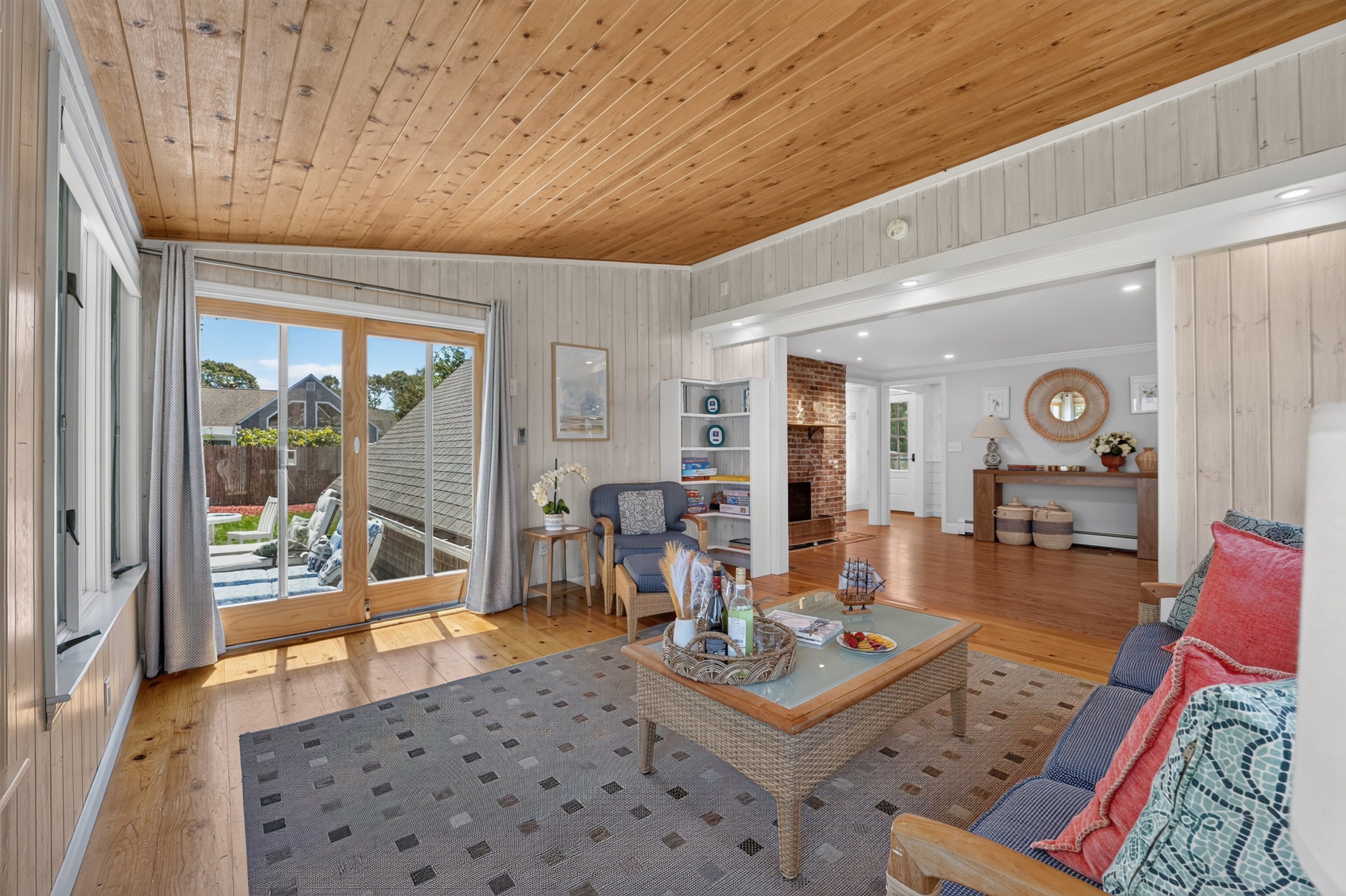 Relax in the sunroom where indoor comfort meets backyard views.