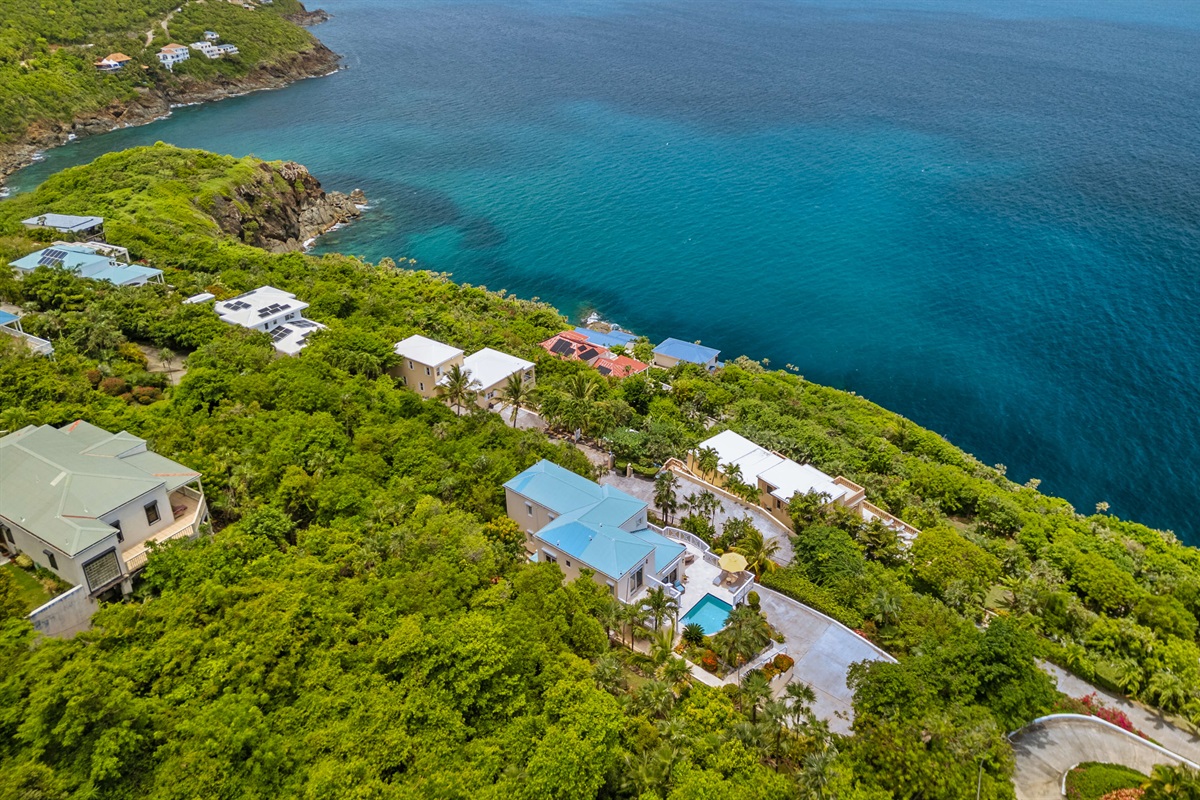 Charming island villa exterior with tropical plants and free parking. A beautiful welcome, every time.