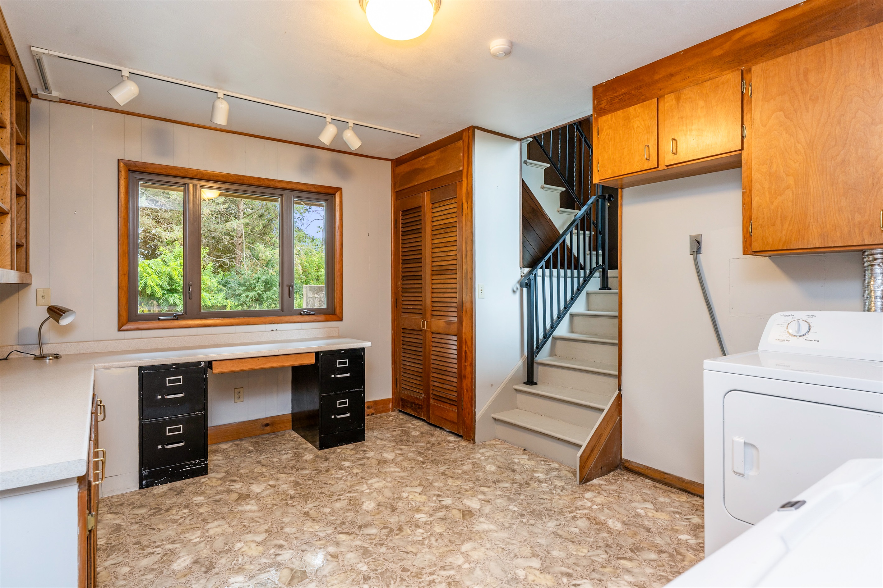 Unique split-level entryway with warm wood paneling, natural light, and open sightlines to multiple levels.