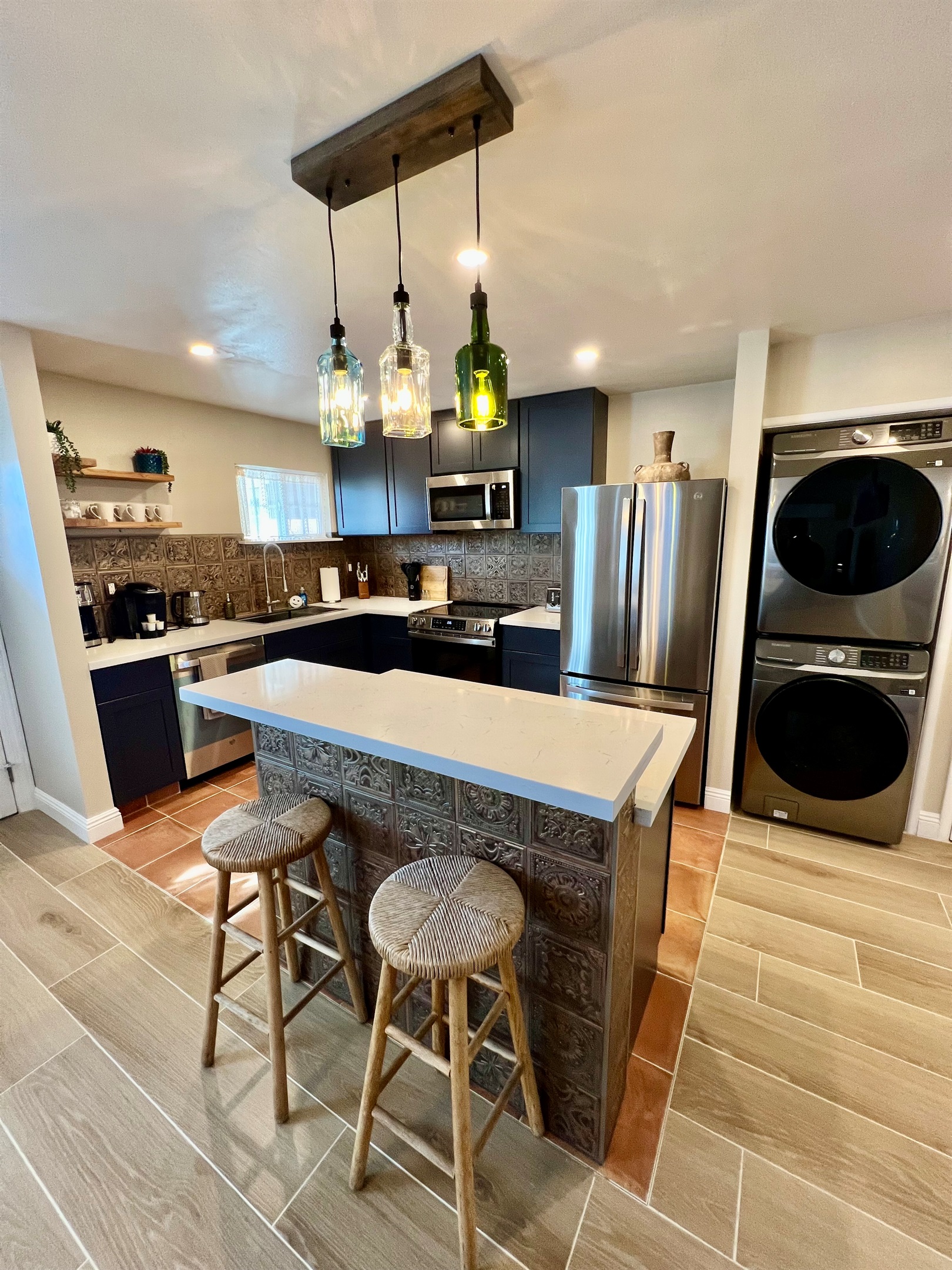Whip up a meal in the fully-equipped modern kitchen, featuring stainless steel appliances and a stylish breakfast bar with seating for two.