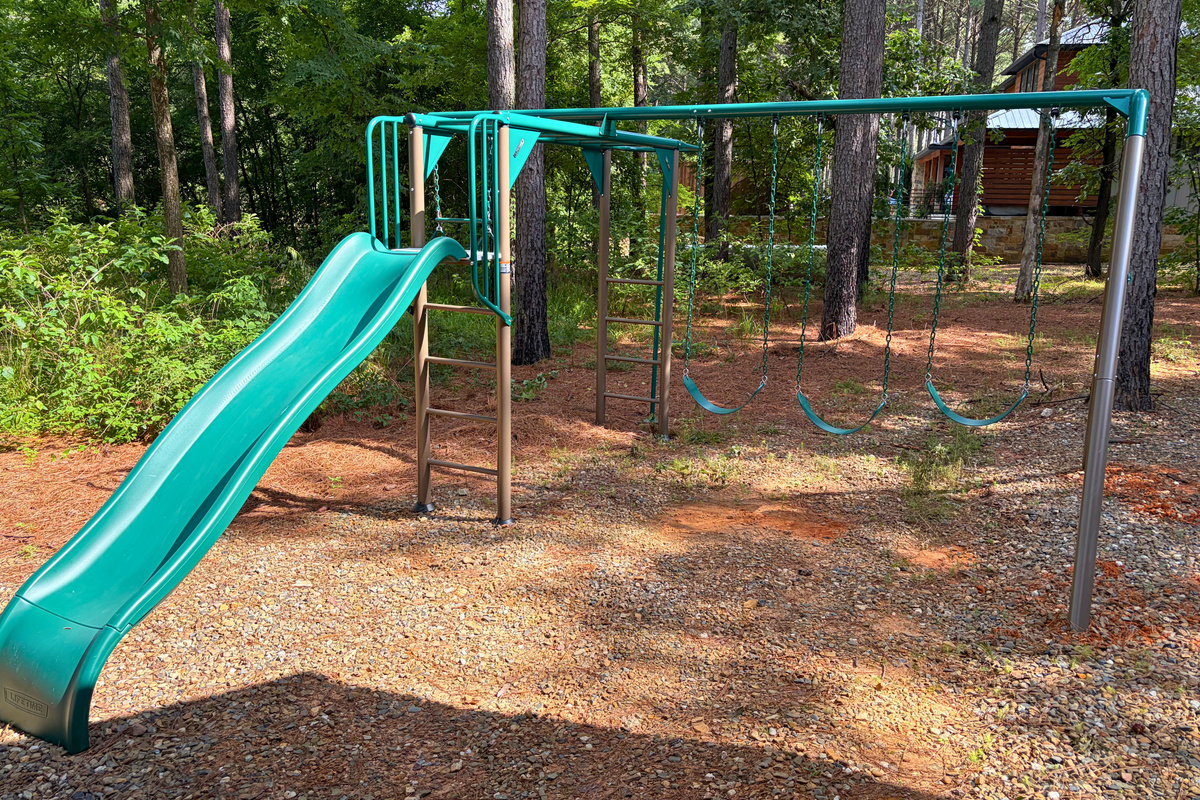 Little ones will love spending time on the playground, complete with swings, monkey bars, and a slide surrounded by the pines.