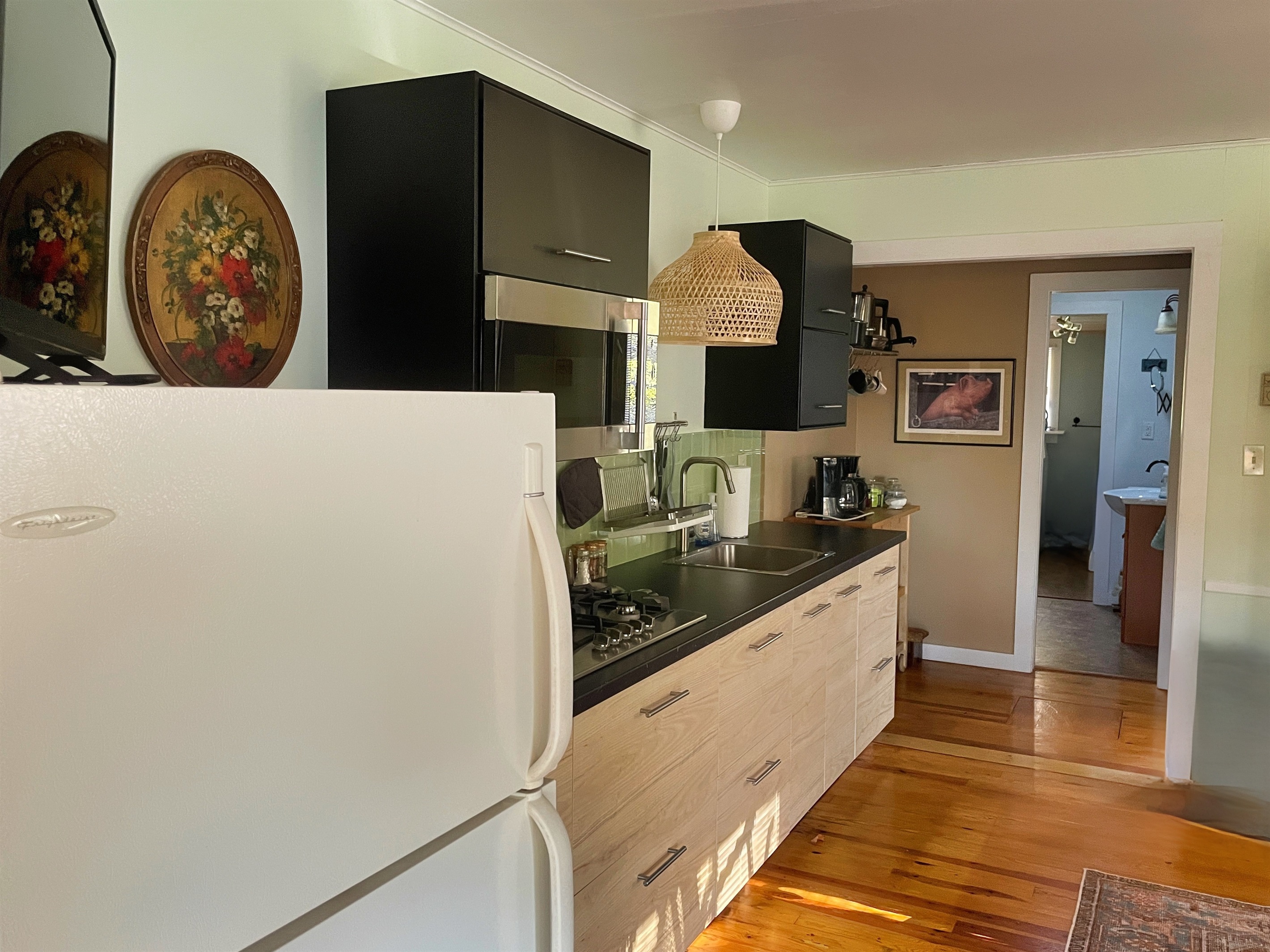 Little Pines - Kitchen with view of the bathroom in the back.