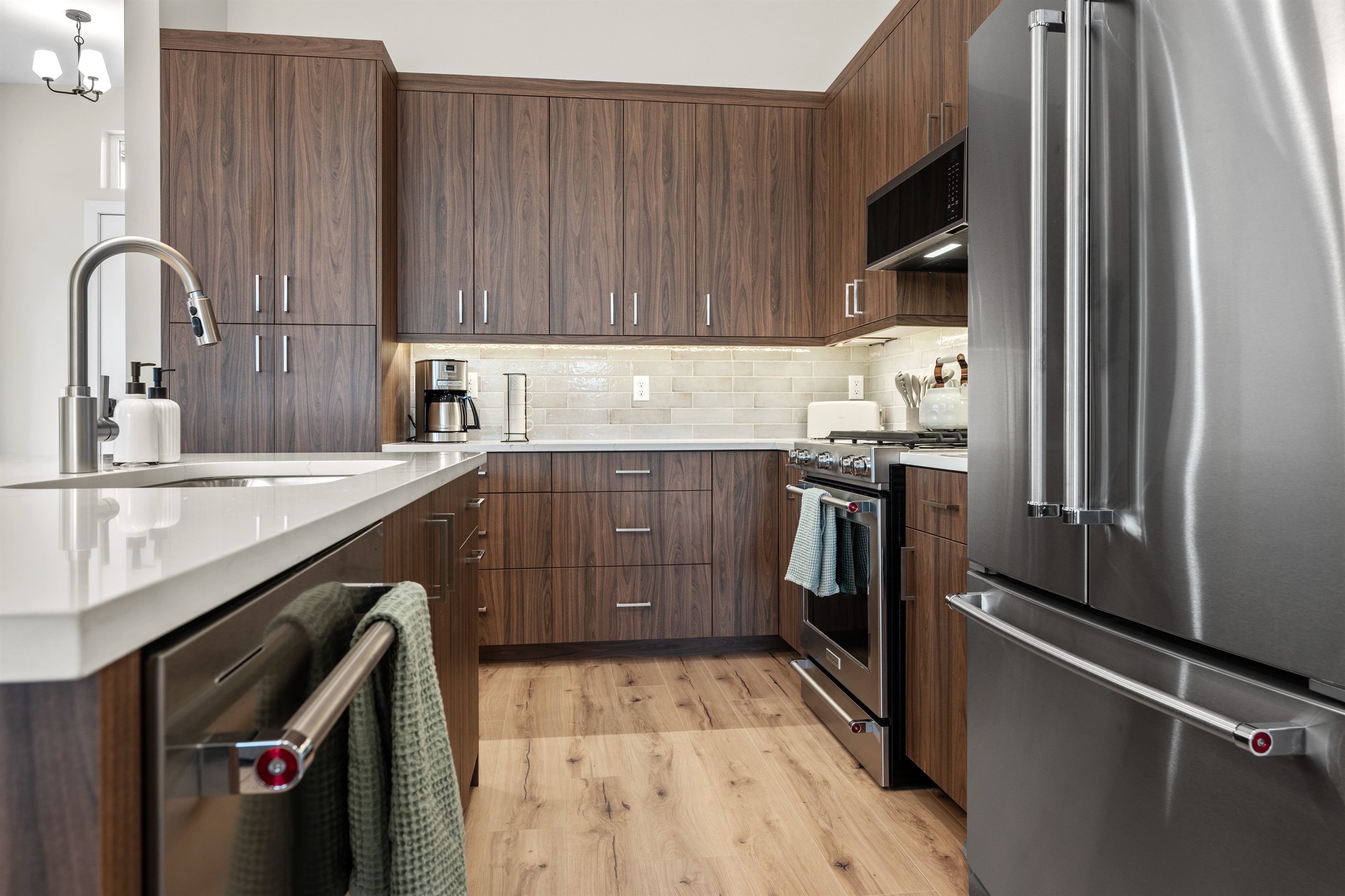 Wood cabinets and spacious quartz countertops for storage and meal prep.