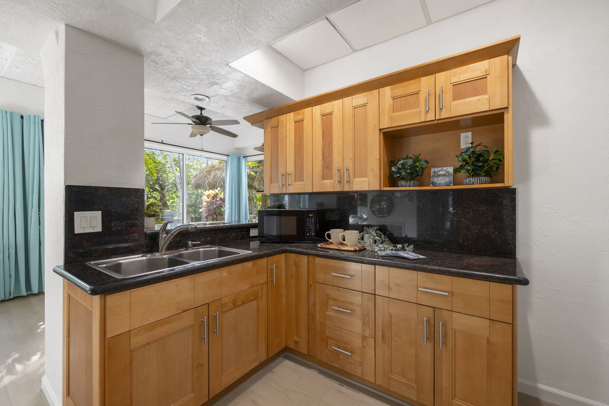 The lower level includes a kitchenete area with another refrigerator, ice machine, and sink.
