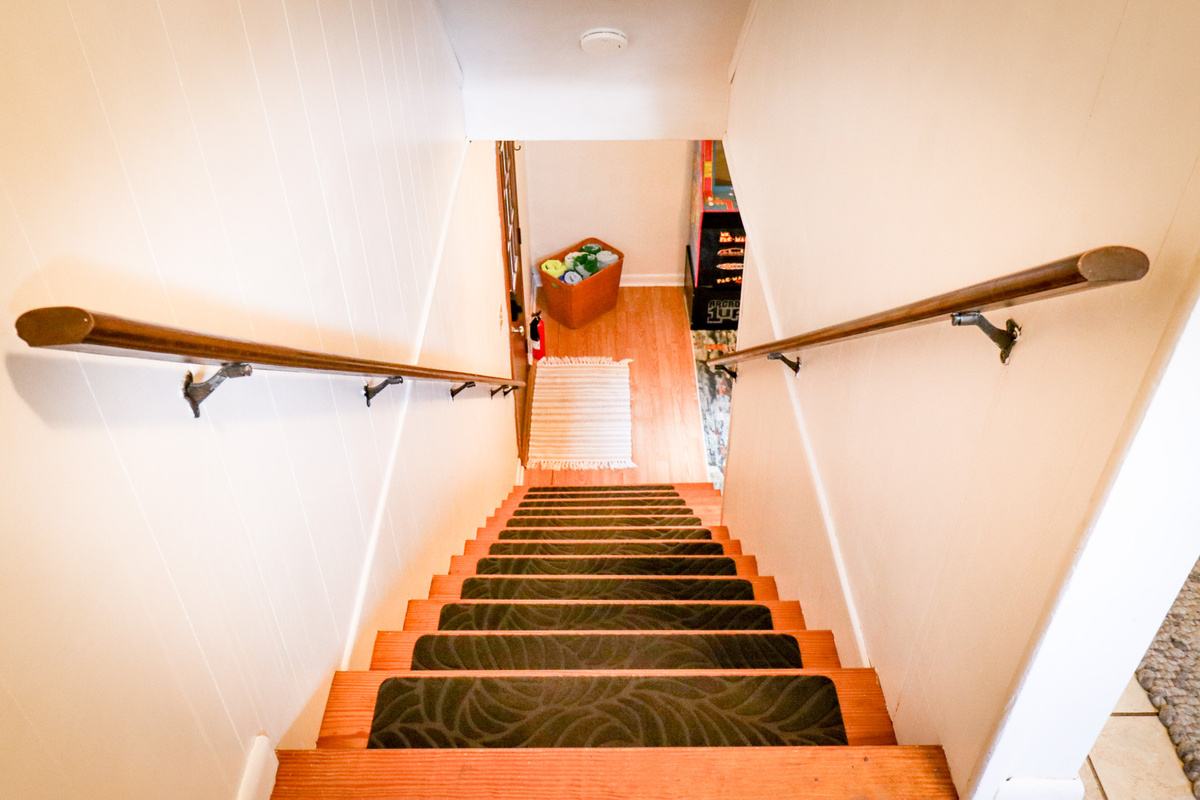 The staircase leads to backyard oasis and the Game Room and additional sleeping space.