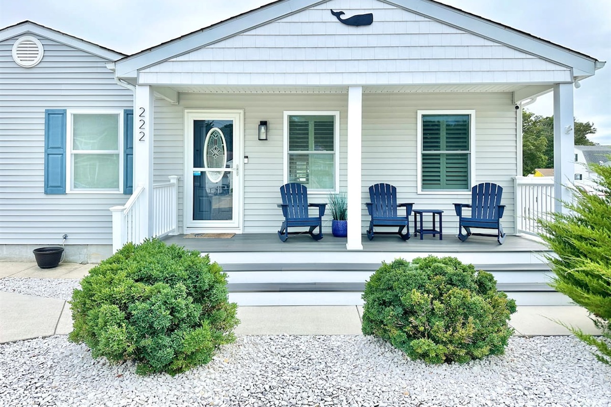 Welcome to your coastal escape, featuring a charming covered front porch with comfortable Adirondack rockers. This inviting entrance is the perfect spot to enjoy your morning coffee or feel the ocean breeze while taking in the quiet neighborhood views.
