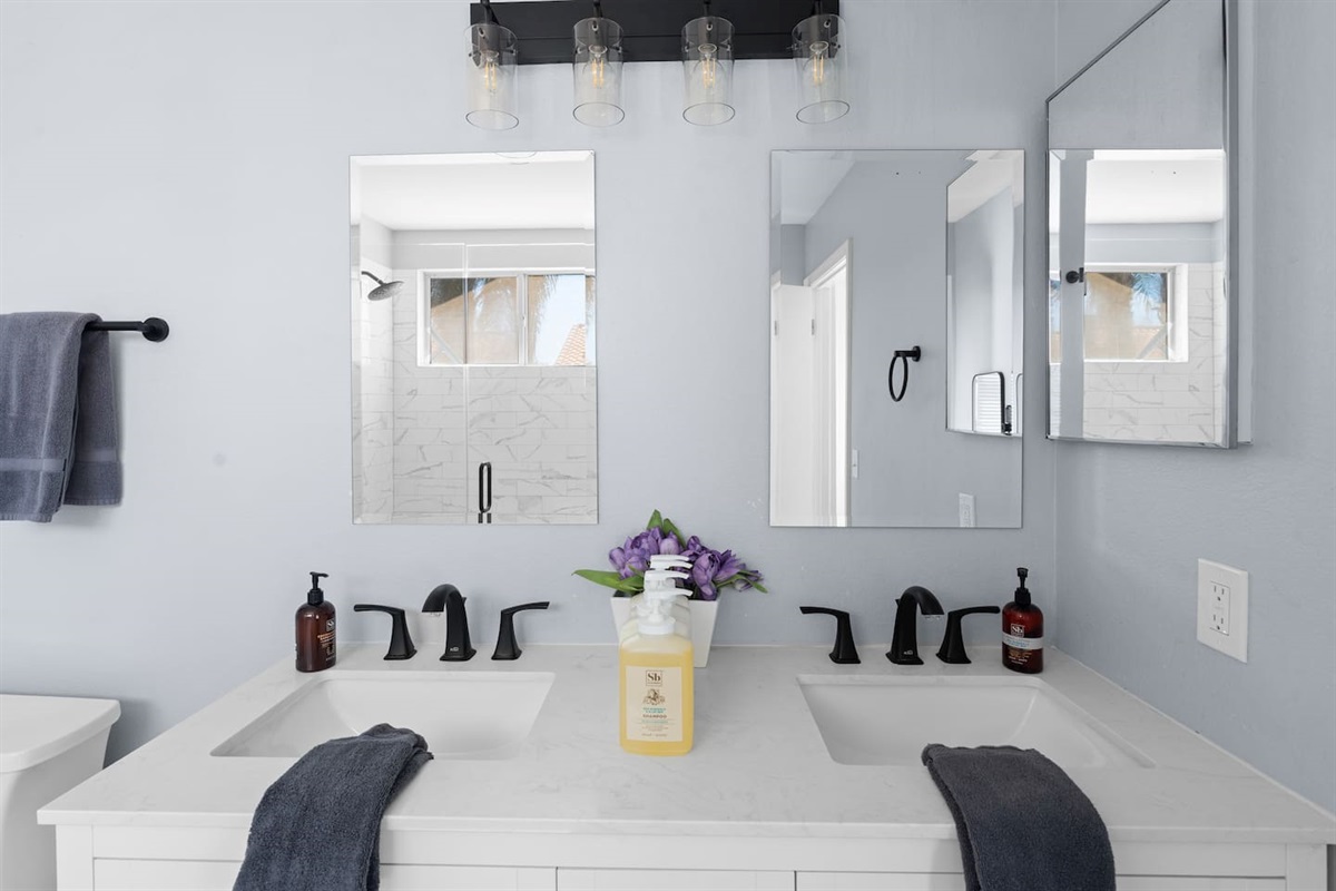 The primary bathroom has two sinks and nice, remodeled finishings.