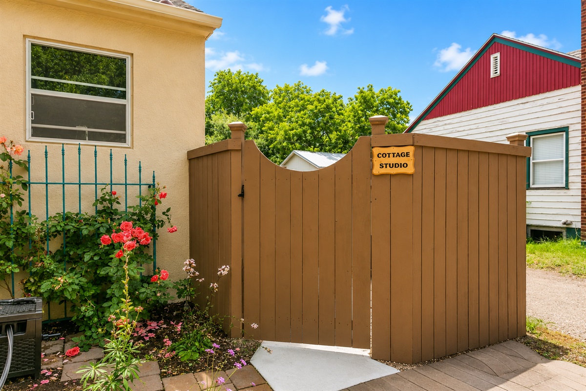 Access this apartment through the gate to the right of the property.