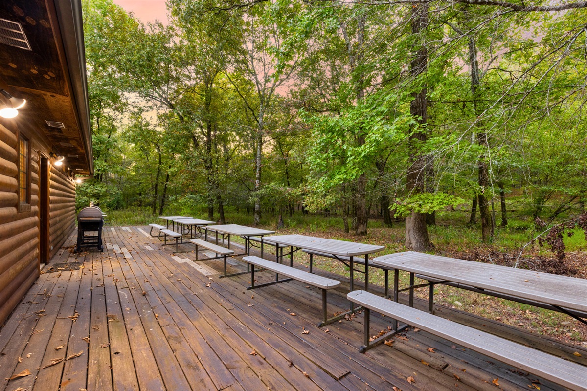The spacious back deck provides plenty of room for outdoor seating and activities surrounded by nature.