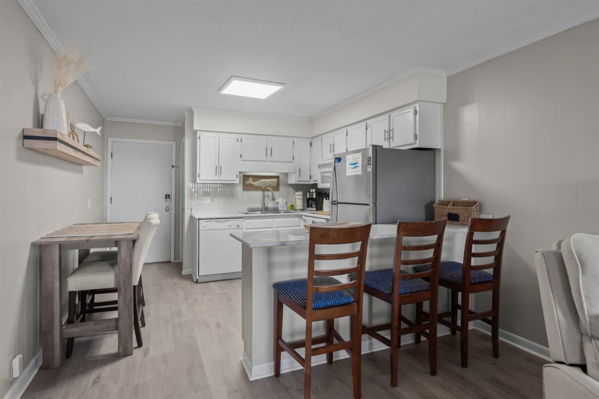 Kitchen Set Up with Plenty of Cabinet Space and Bar Seating