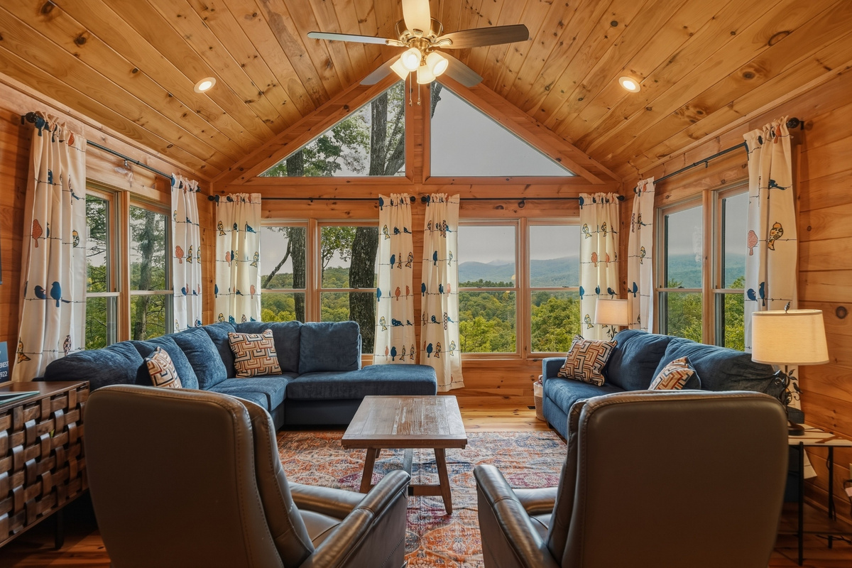 Living area with lots of seating, fire place and smart TV