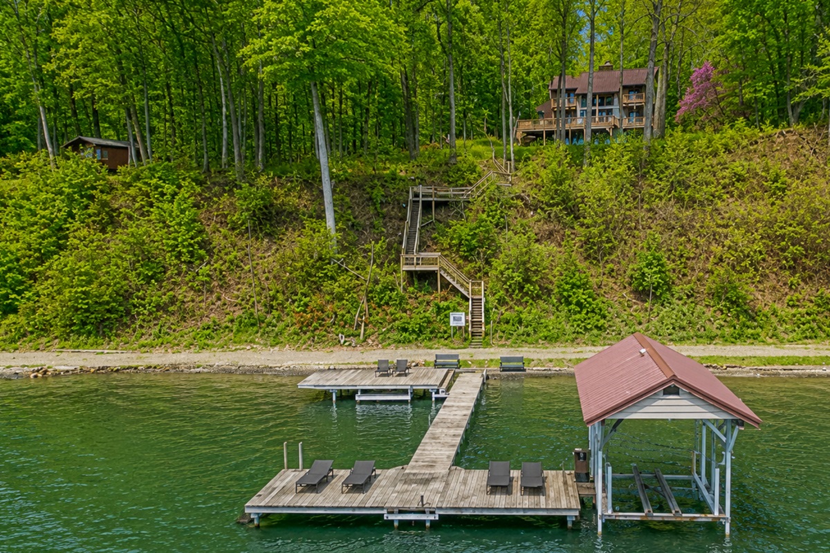 Wooded hillside leads down private steps to the dock on crystal-clear Cayuga Lake—tie up the boat, swim, or soak in Finger Lakes sunsets 🚤🌞🌊Hoist not available