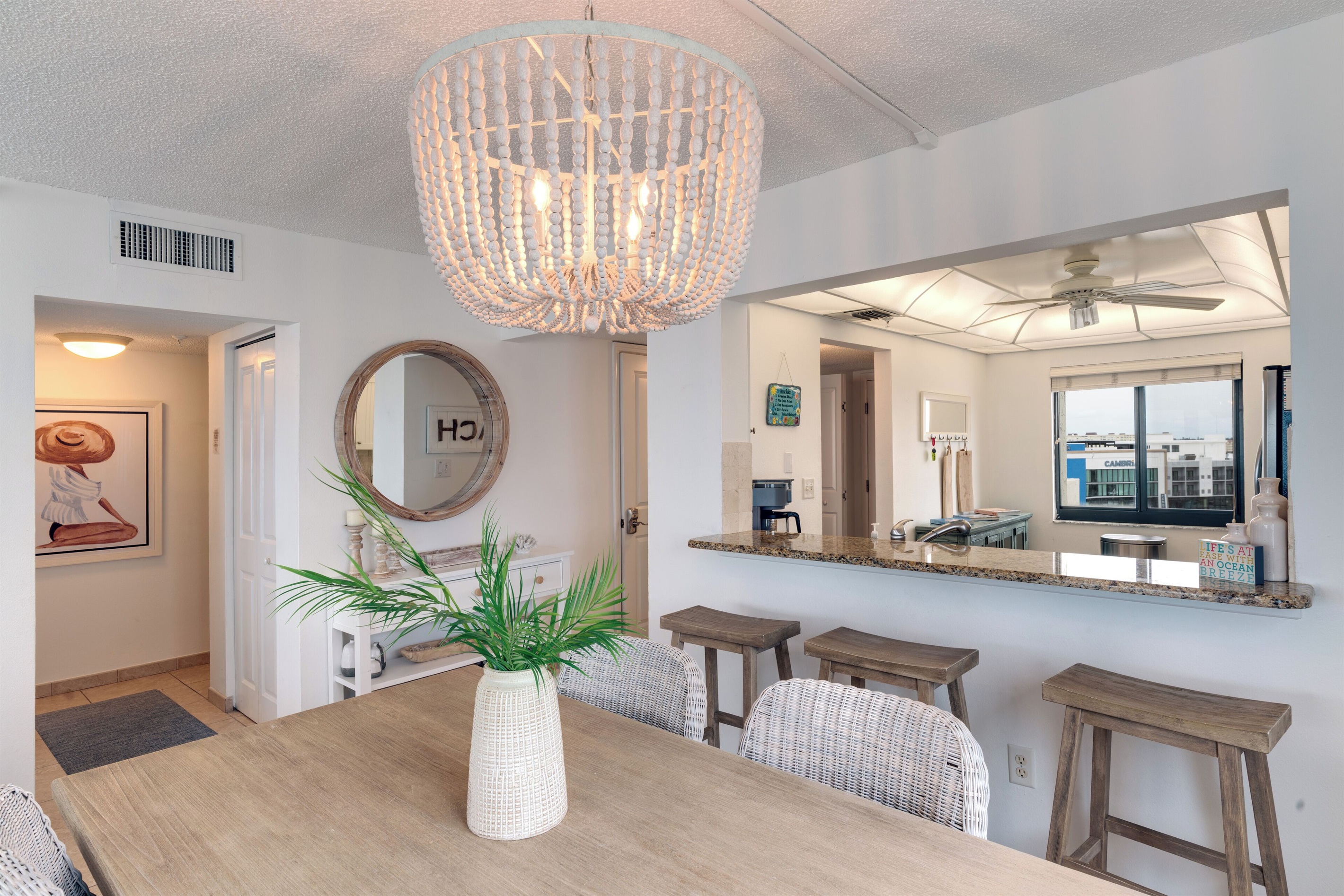 Seating for four at the table, plus three bar stools at the kitchen countertop.