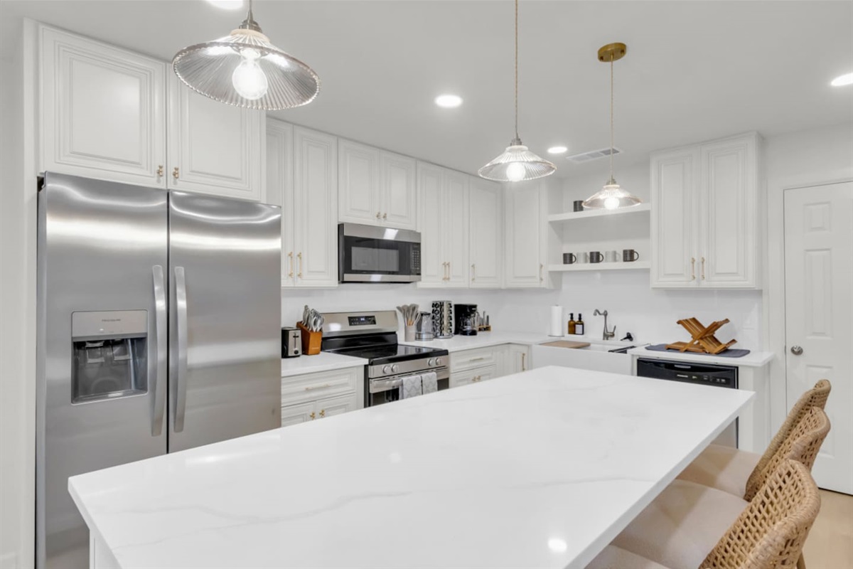Fully equipped kitchen with Frigidaire fridge, oven, and electric cooker. Includes cooking basics, dishes and cutlery, and a filter coffee maker for effortless at-home dining.