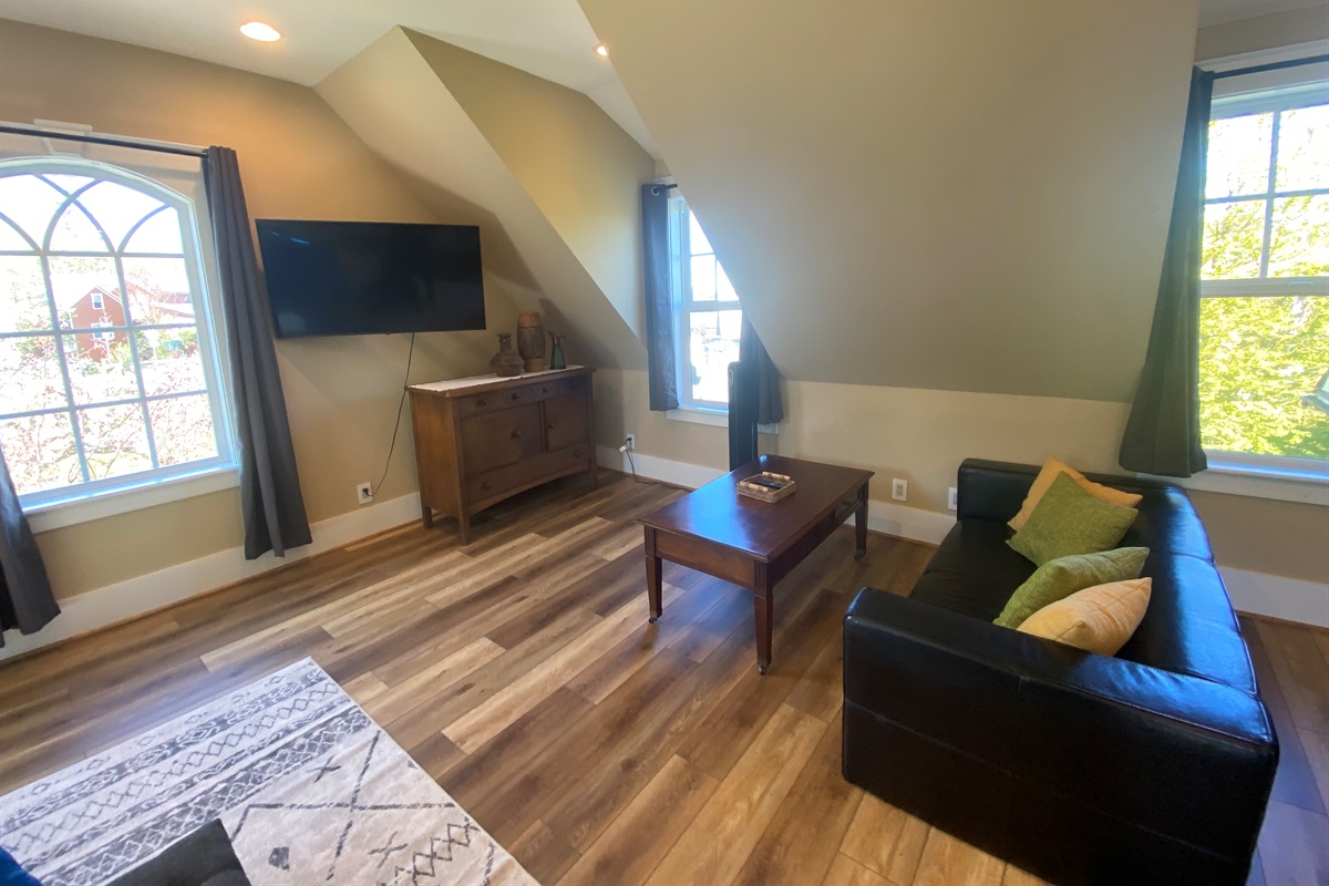 The spacious bonus room has its own seating area. With a swivel television you can start watching your show on the couch than pull it out and finish watching it bed. 