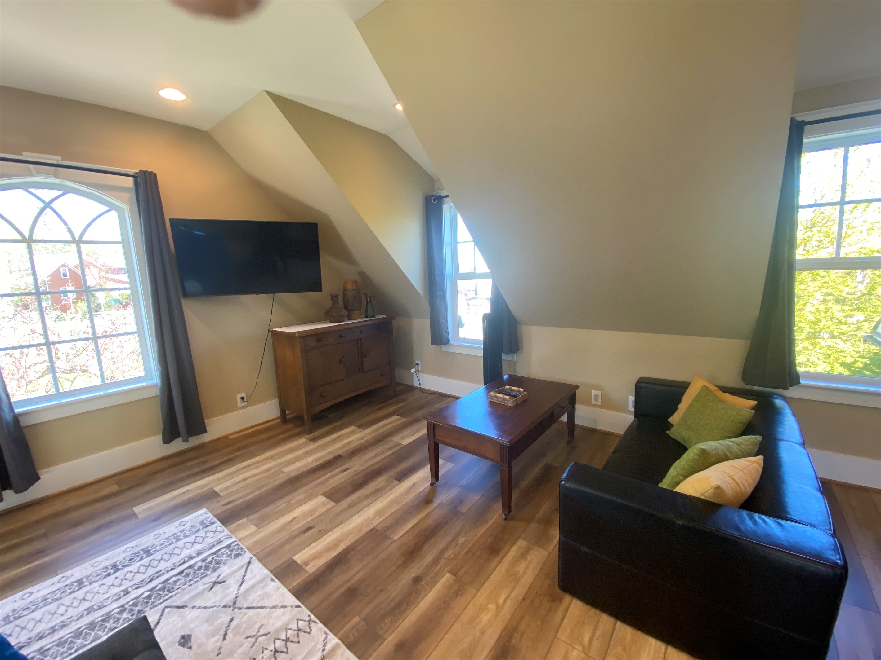 The spacious bonus room has its own seating area. With a swivel television you can start watching your show on the couch than pull it out and finish watching it bed. 